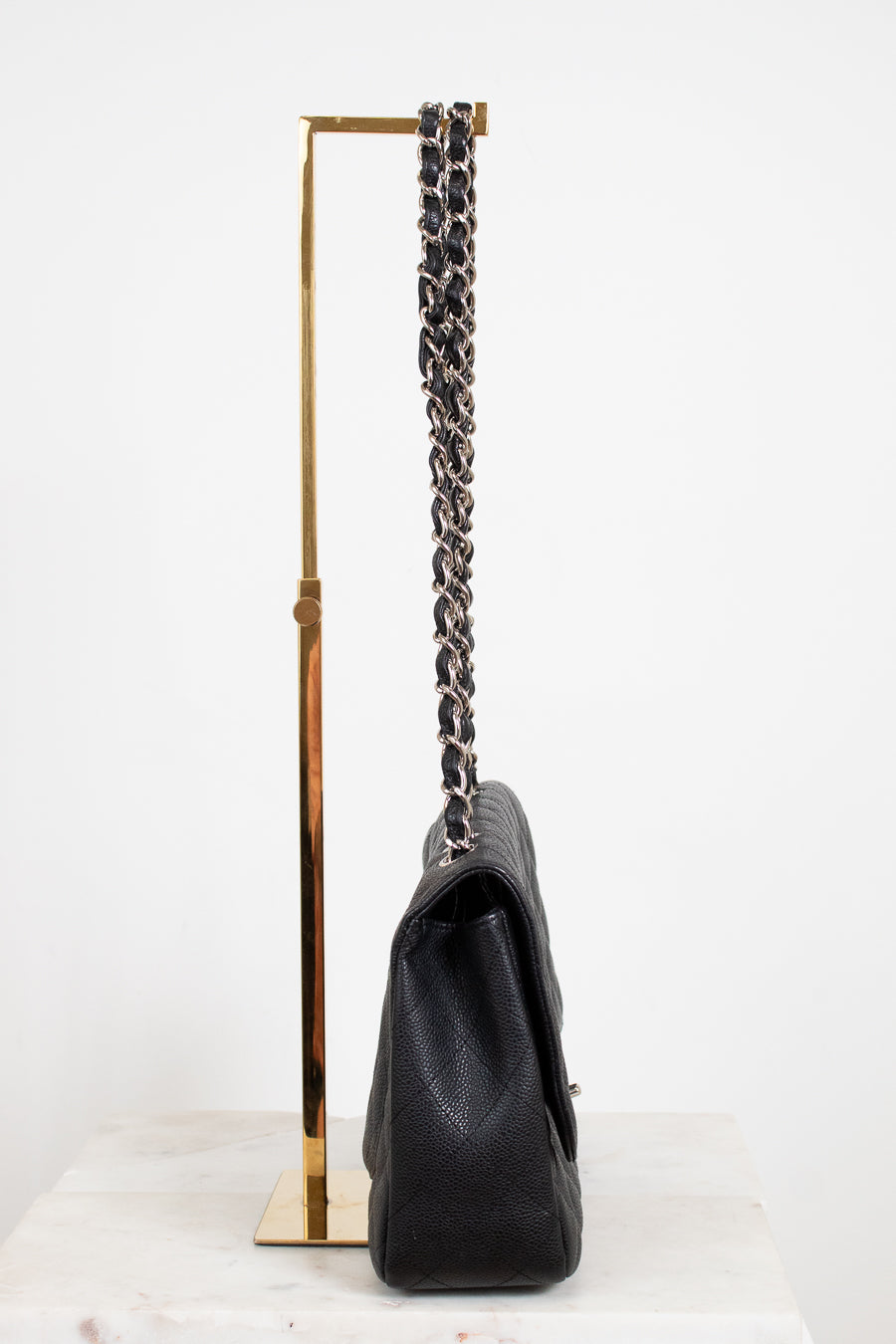 Black handbag with a chain strap on a white background