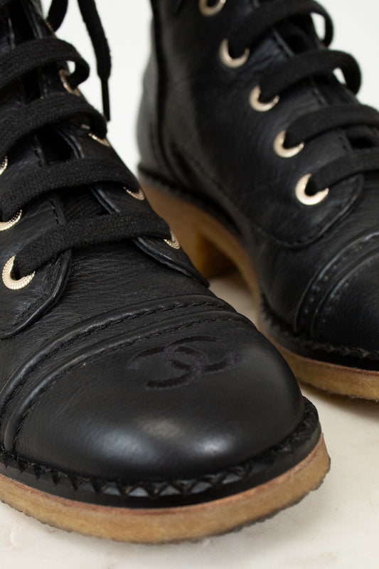 Close up of black boot toe on white background