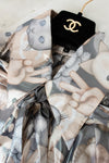 Close up of Chanel blouse collar with mixed cat pattern on black hanger with Chanel logo