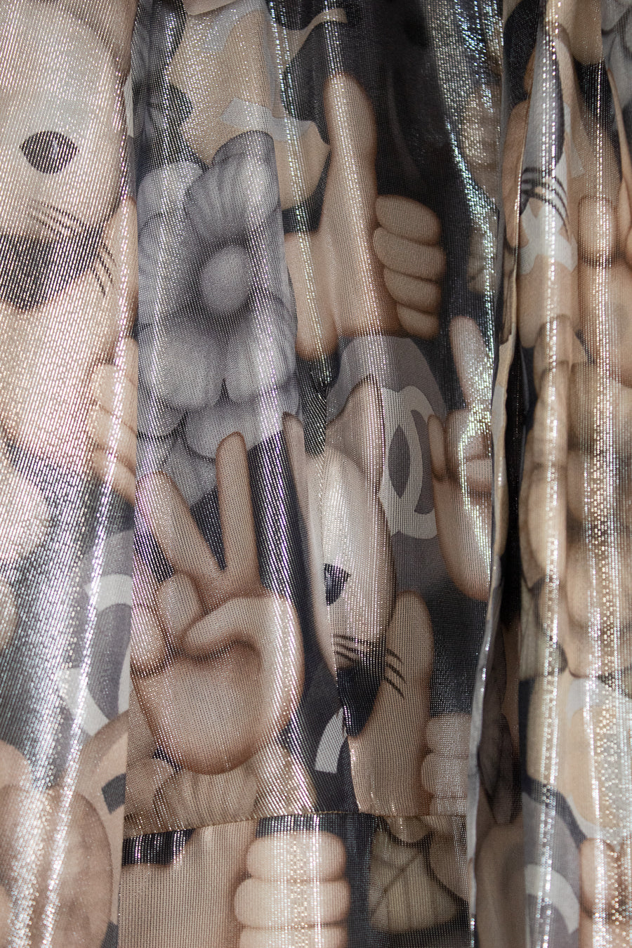Close-up of a cat-patterned fabric with brown, black, and beige colors.