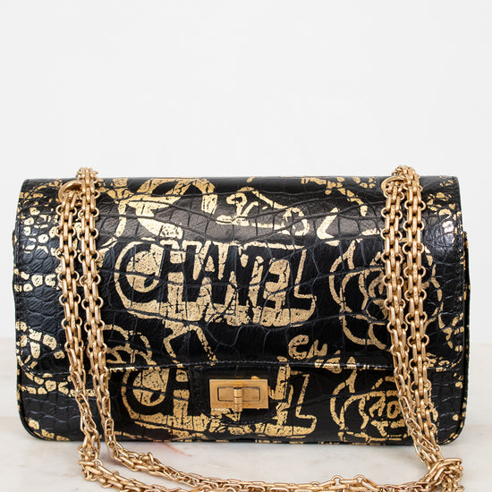 Chanel handbag with gold chain on a white background