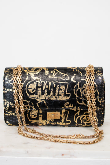 Chanel handbag with gold chain on a white background