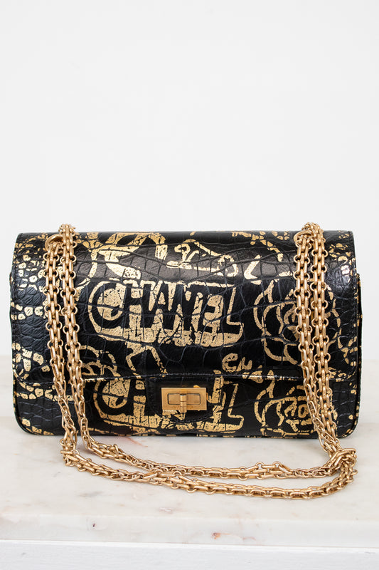 Chanel handbag with gold chain on a white background