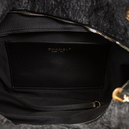 Black interior of a gray textured back being held open