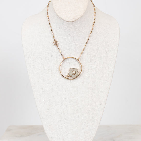 Necklace with a pendant on a mannequin bust against a white background