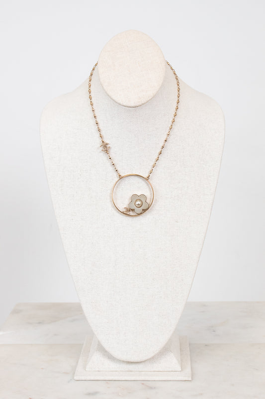 Necklace with a pendant on a mannequin bust against a white background