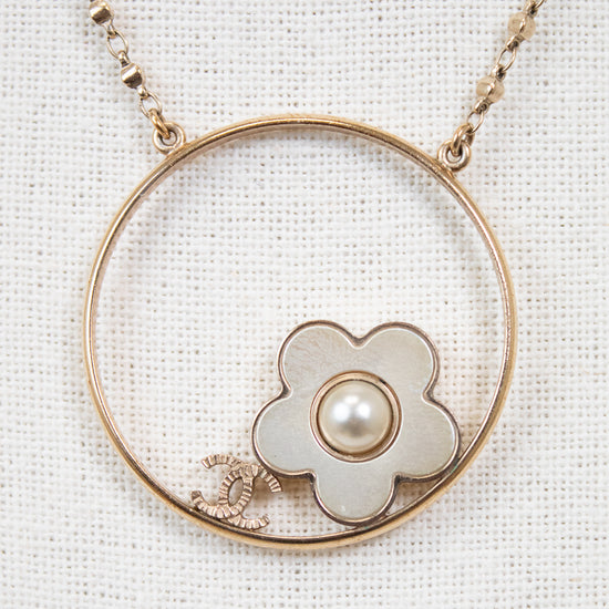 Necklace with a floral pendant and pearl on a white background