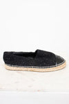 Side view of black espadrilles with jute soles on white background.