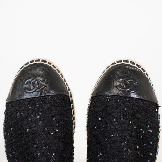 Black Chanel shoes with sequin details on a white background