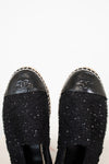 Black Chanel shoes with sequin details on a white background