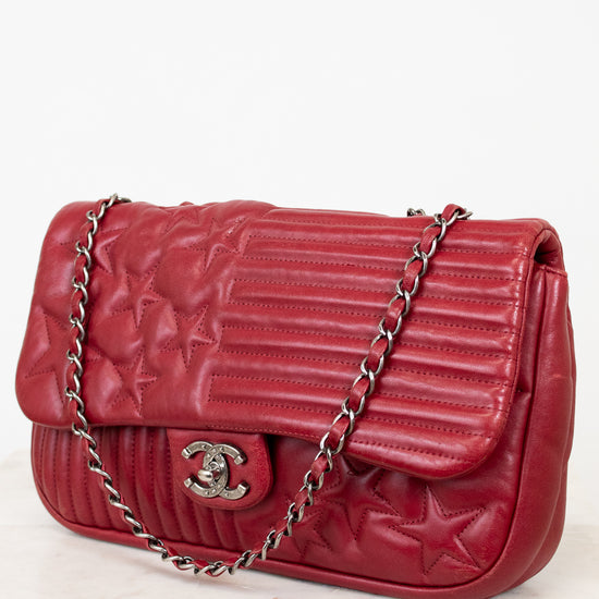 Red Chanel quilted handbag on white background