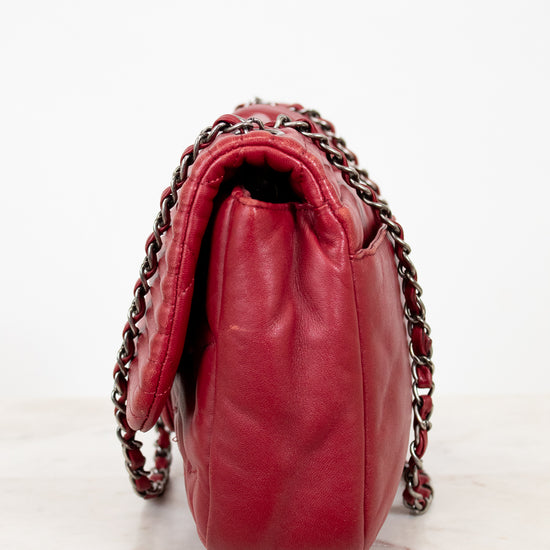 Red handbag with chain detail on a white background