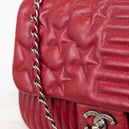 Red quilted star handbag on white background