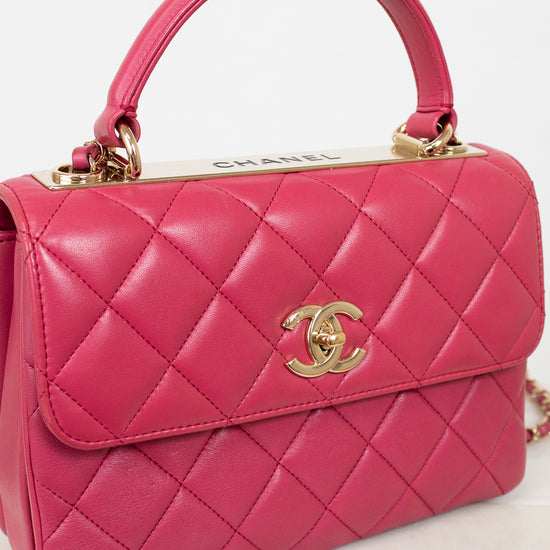 Pink quilted handbag with Chanel logo on a light background