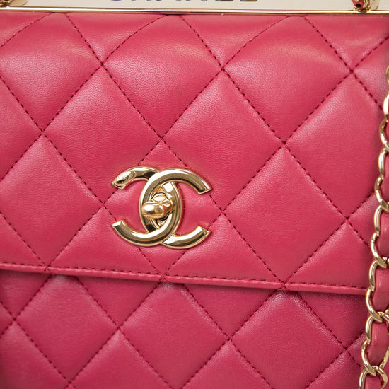 Pink quilted handbag with gold chain and Chanel logo on a white background
