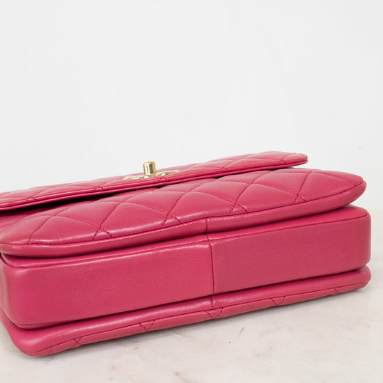 Pink quilted handbag on a light marble surface