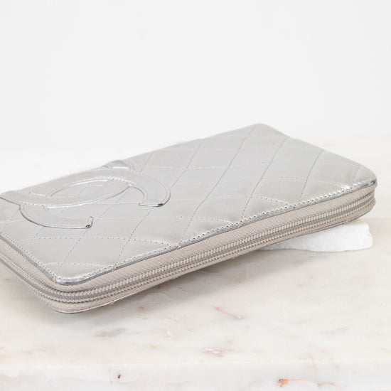 Silver quilted wallet on a marble surface