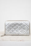 Silver quilted wallet with a brand logo on a white background