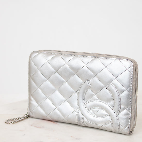Silver quilted clutch on a white surface