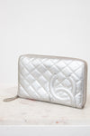 Silver quilted clutch on a white surface
