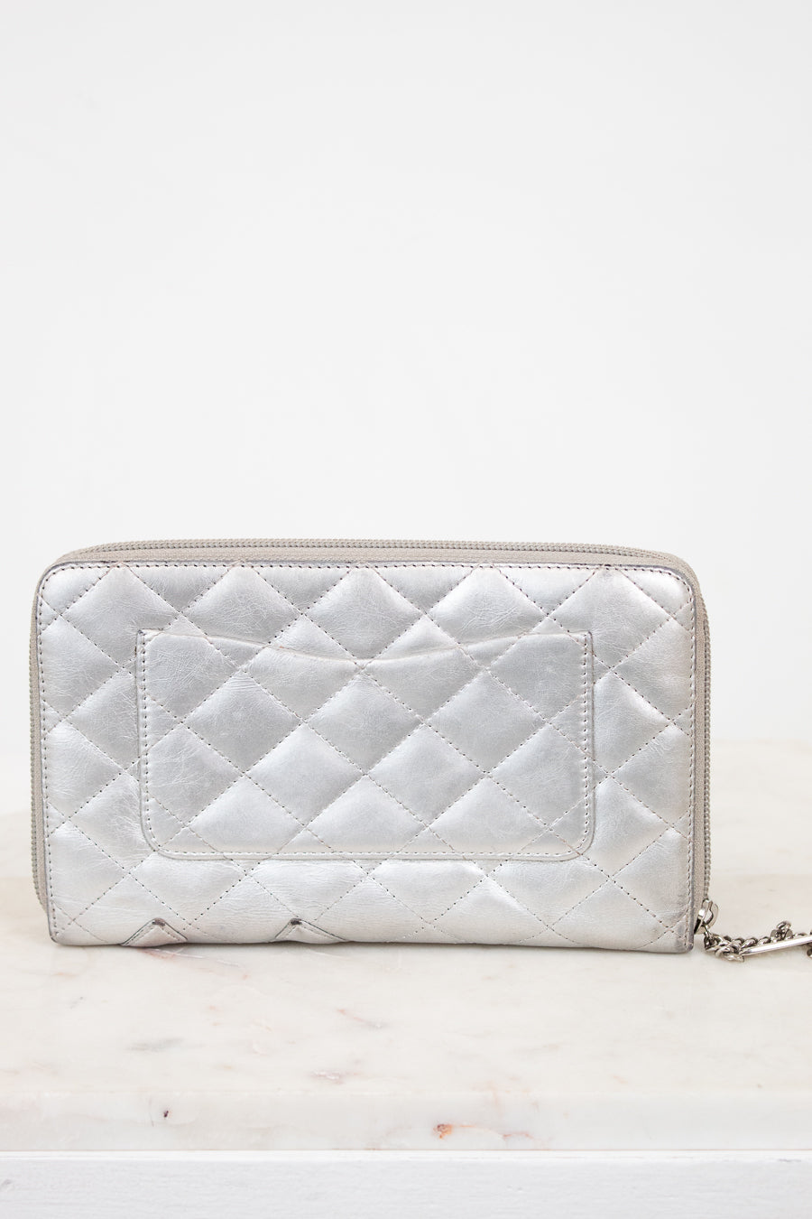 Quilted silver wallet on a white background