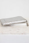 Quilted silver wallet on a white background