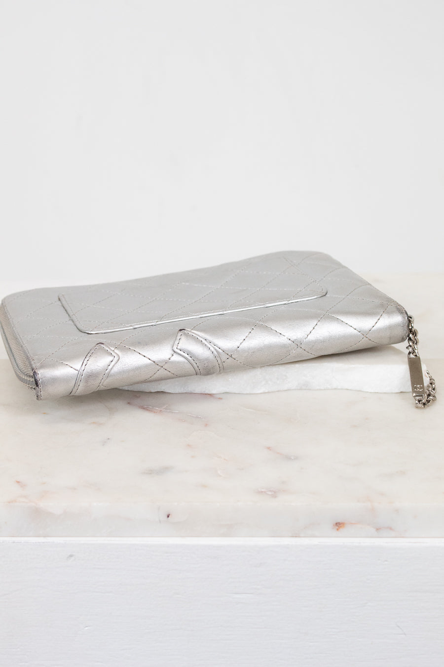 Quilted silver wallet on a white background