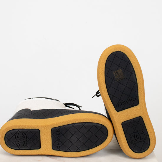 Pair of shoes with tan soles and black soles on a white background