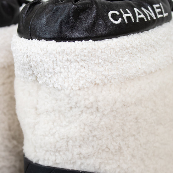 White and black Chanel shoes with quilted design and logo on a white background