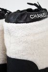 White and black Chanel shoes with quilted design and logo on a white background