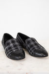Pair of black and gray checkered loafers on a white background