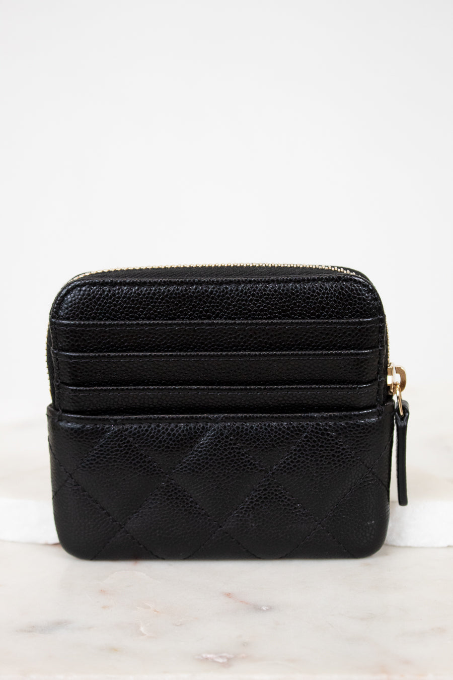 Black quilted wallet on a white background