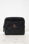 Black quilted wallet with gold logo on a white background