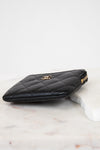 Black quilted wallet with gold logo on a white background