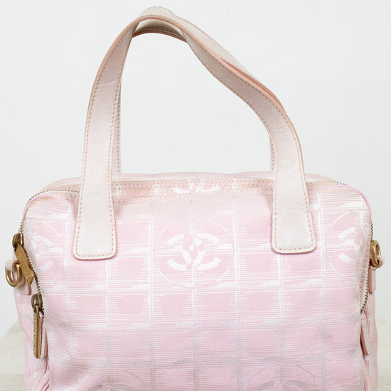 Pink handbag with a logo on a light background