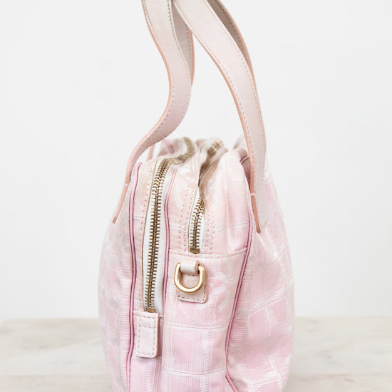 Pink tie-dye drawstring bag with a gold zipper on a white background