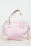 Pink handbag with white handles on a light gray background