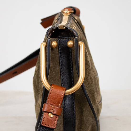 Handbag with gold hardware and leather strap on a white background
