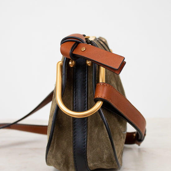 Olive suede handbag with gold hardware on a white background