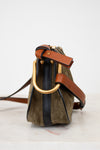 Olive suede handbag with gold hardware on a white background