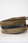 Olive suede bag with black strap on a white background