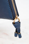 Blue leather wallet with gold zipper and matching strap on a white background