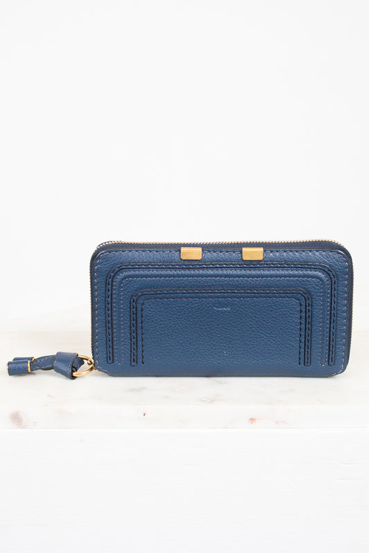 Blue wallet with gold accents on a white background