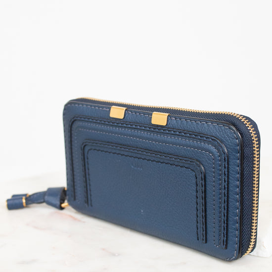 Blue wallet with gold zipper on a white background