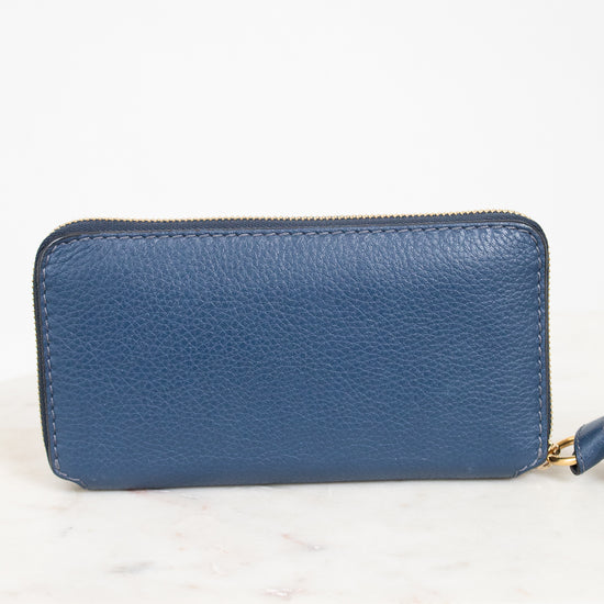 Blue wallet with a gold zipper on a white background