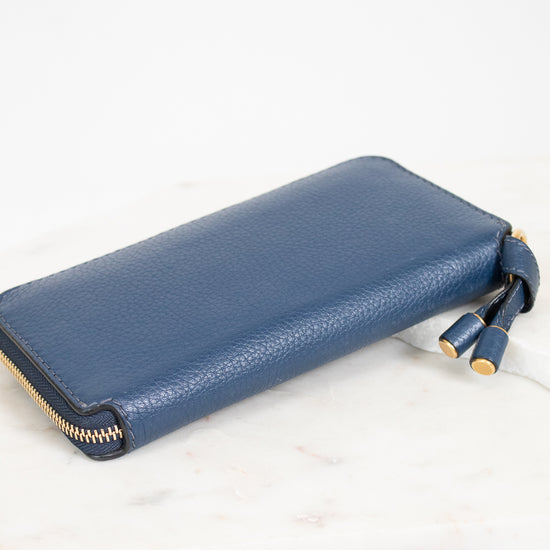 Blue wallet with gold zipper on a white background