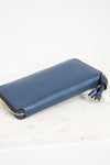 Blue wallet with gold zipper on a white background