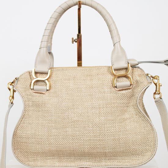 Beige handbag with gold accents on a white background