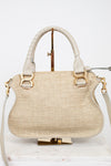 Beige handbag with gold accents on a white background