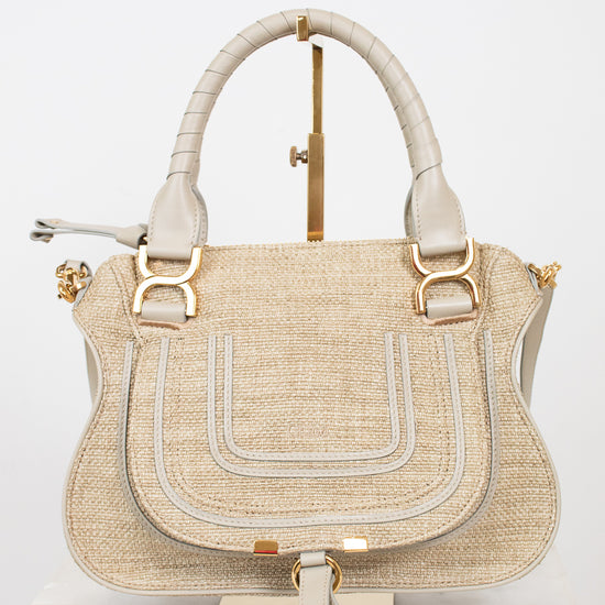 Beige handbag with gold accents on a white background